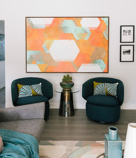 In the setting below, a large piece of art is mounted directly above a conversation area in the main living area. 