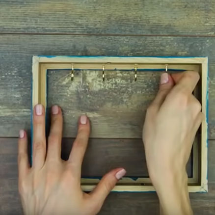 screw cup hooks into the picture frame