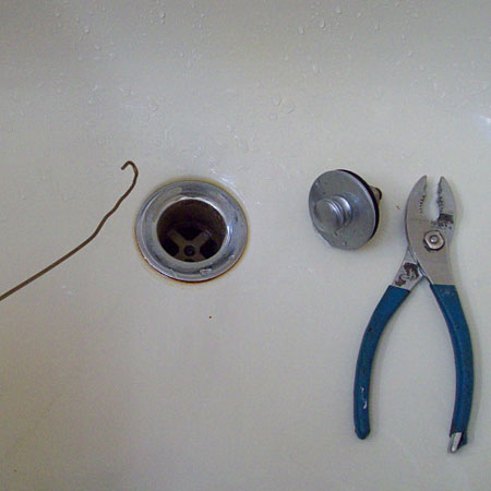 bend coathanger to remove hair from blocked drain