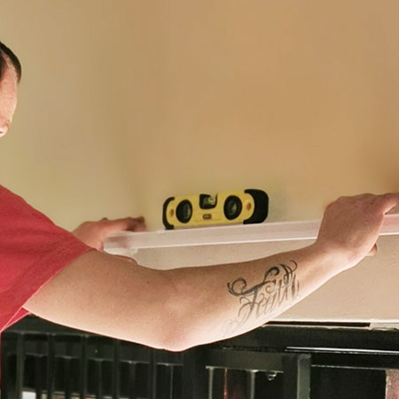 use spirit level to ensure curtain track is straight