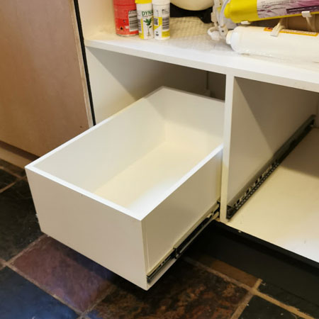 inserting pullout drawers in under sink kitchen storage cupboard