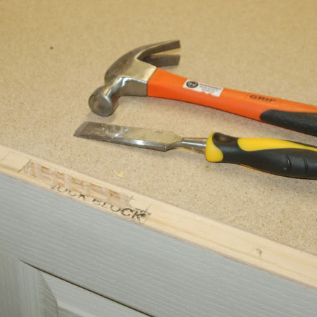 use hammer and chisel to remove wood from lock block
