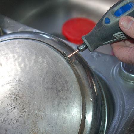 use dremel multitool to remove burnt-on grease on pots and pans