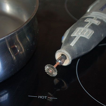 use dremel multitool to remove burnt-on grease on pots and pans