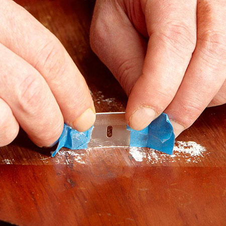 scrape paint from the wood surface