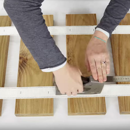 secure webbing to the back of the planks