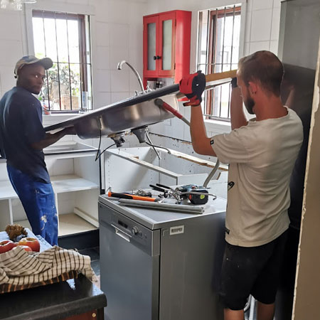 removing the old kitchen countertop and cupboards