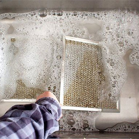 use hot water to clean extraction hood filters