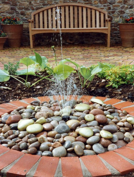 circular water feature adds interest to garden
