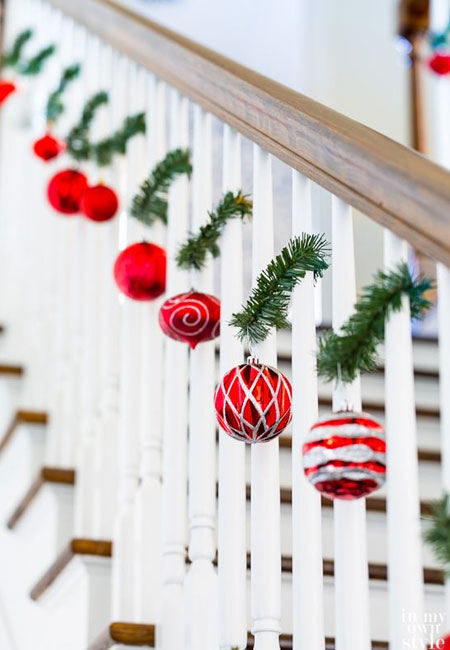 DRAPE BAUBLES AND FOLIAGE OVER A BALUSTRADE
