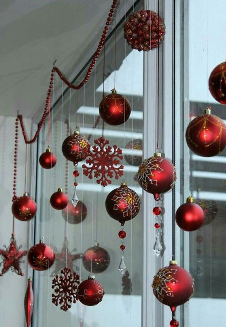 hang colourful baubles in front of window