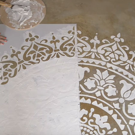 apply relief plaster design over stencil