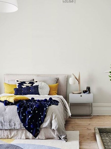 white bedroom with pops of colour