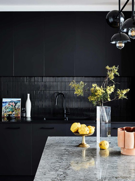 black kitchen with black countertops