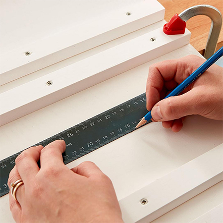 mark holes for mounting board onto wall