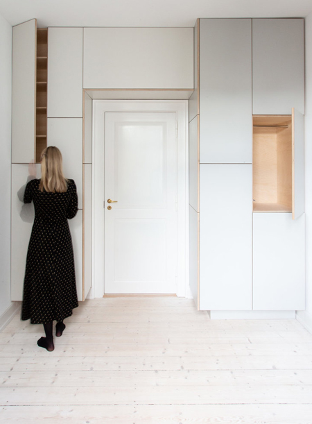 built-in cupboards arranged around bedroom door