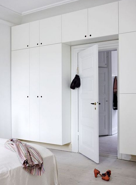 built-in clothing cupboards around doorway