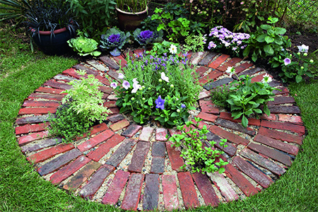 plant flowers inside paving brick circle