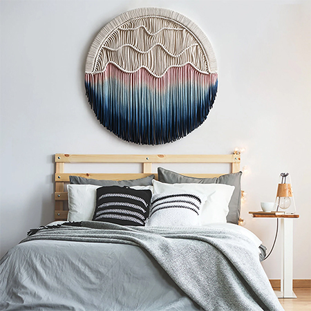 macrame or tapestry above bed headboard