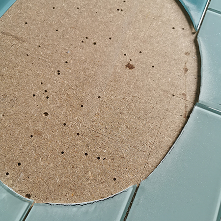 cut curved tiles to fit around sink or toilet