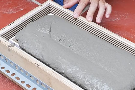 fill form or frame with wet cement